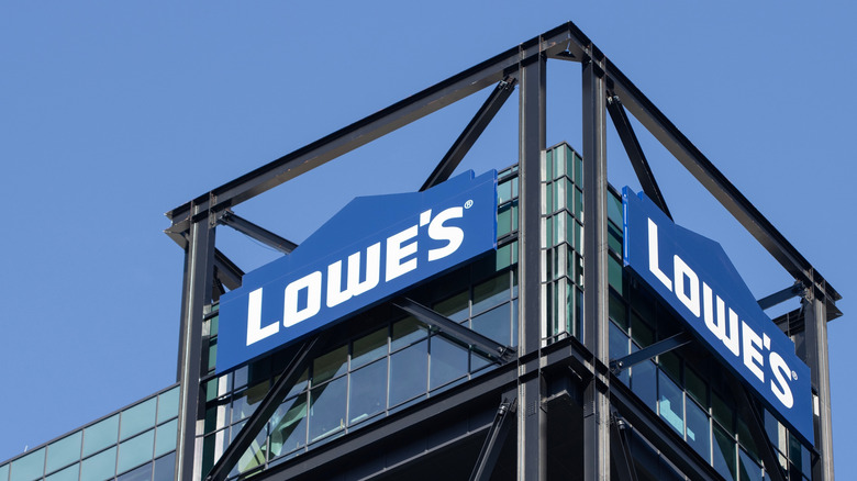 The roof corner of a Lowe's storefront with two company logos visible.