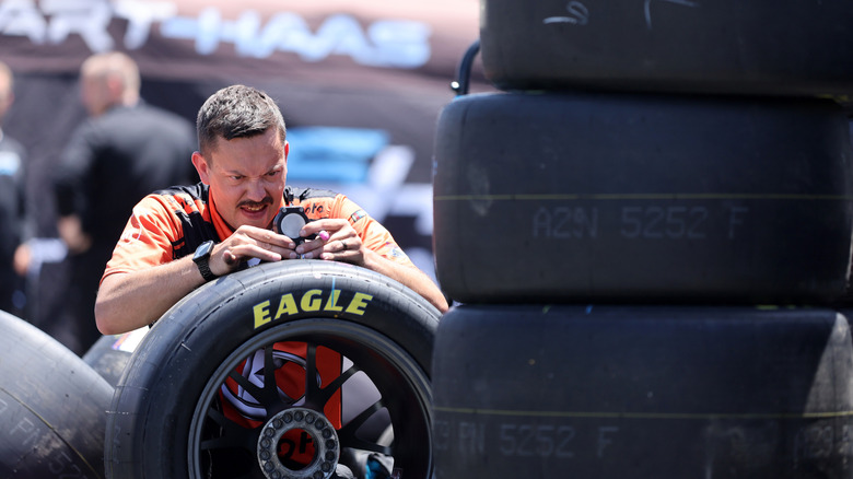A tire specialist works on tires during practice for the NASCAR Cup Series Toyota/Save Mart 350 at Sonoma Raceway.