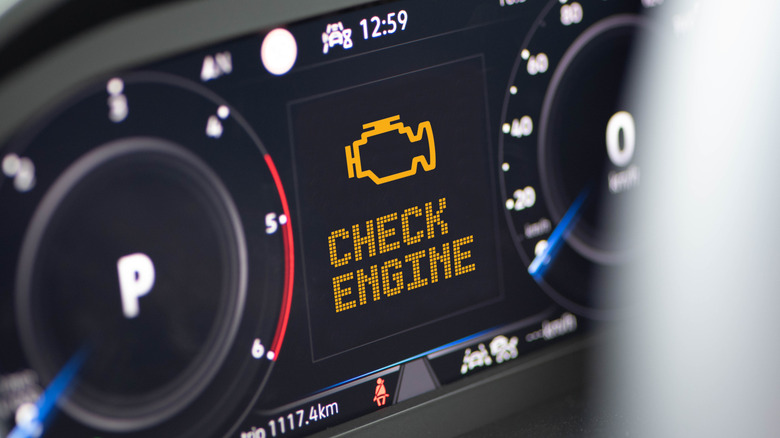 Dashboard of a car with Check Engine warning message displayed