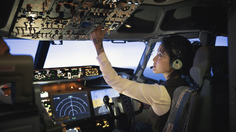 A pilot inside the cockpit of an airplane