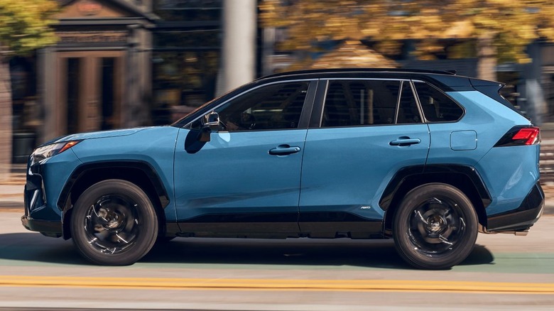 Blue 2024 Toyota RAV4 driving