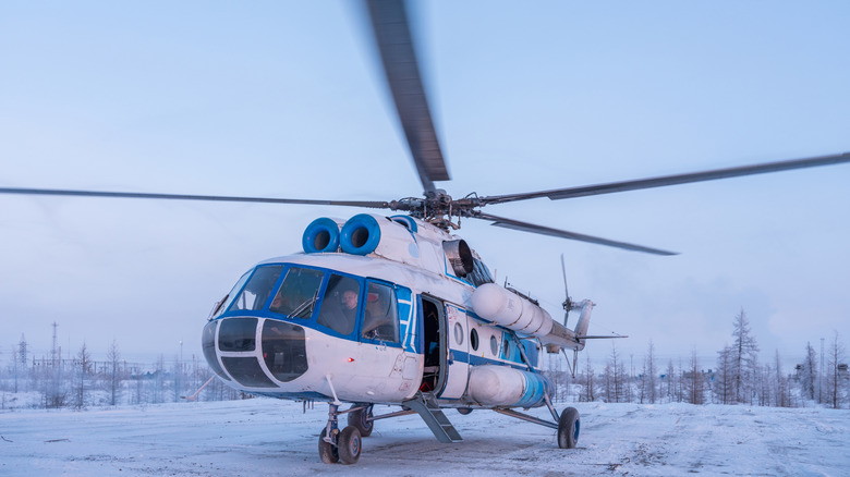Helicopter landed in snowy region.