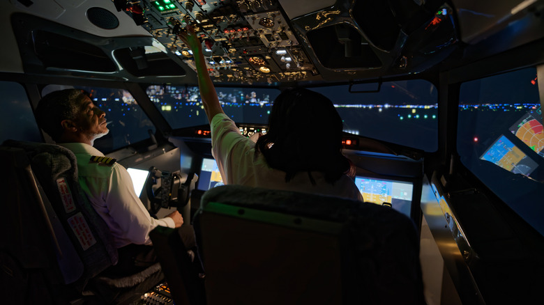 Pilots in aircraft cockpit.