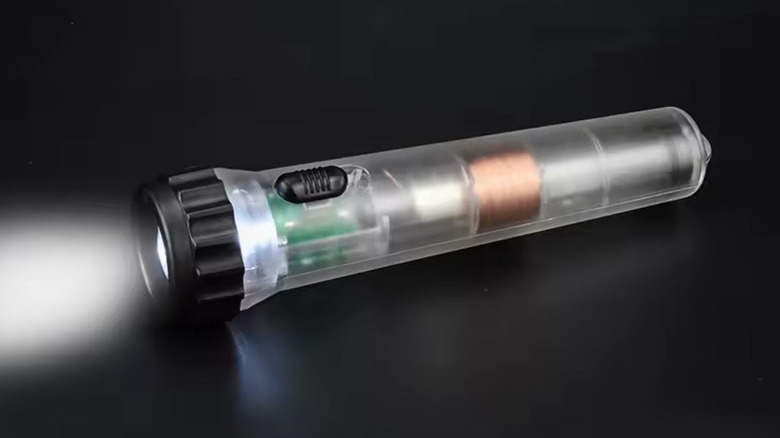 Picture of an illuminated Faraday Shake Flashlight against a black background