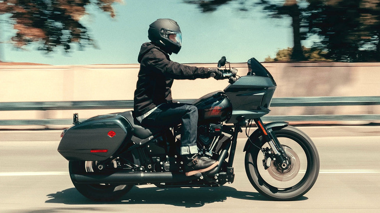 Person riding a Harley-Davidson down the street