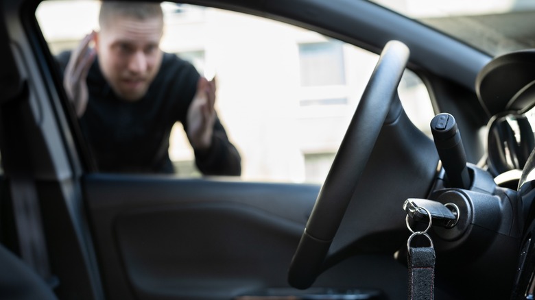 Thief looking in at keys sitting in ignition