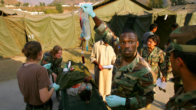 A sick patient is transferred to an ambulance at the U.S. Army Mobile Army Surgical Hospital