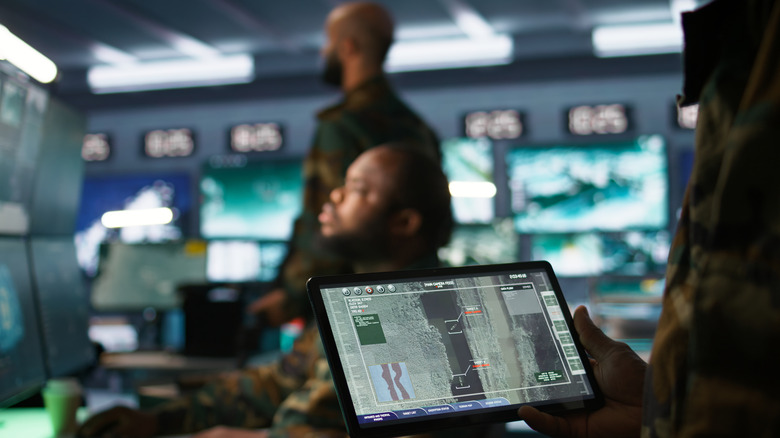 Military command center with several computer monitors