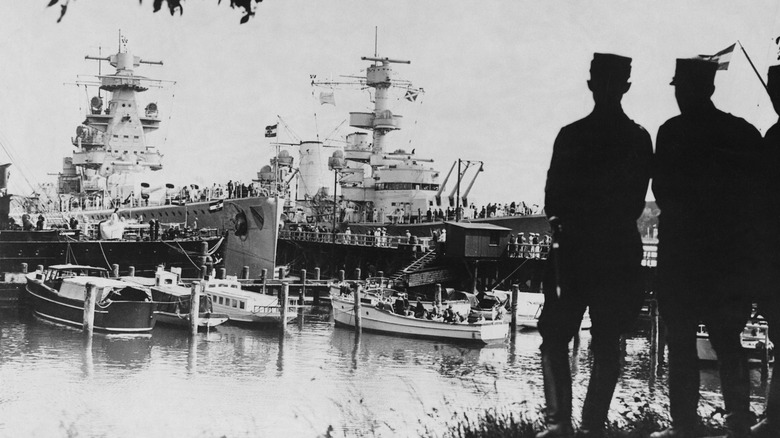 Two pocket battleships at a dock