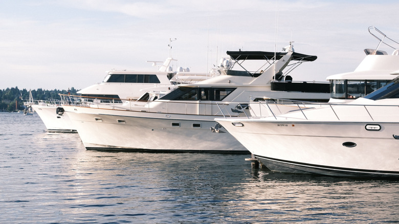 three large yachts docked in a harbor