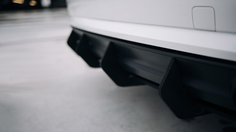 Close-up of rear diffuser strakes on a white passenger car