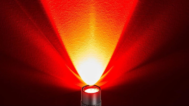 A flashlight emitting a red light across the whole background