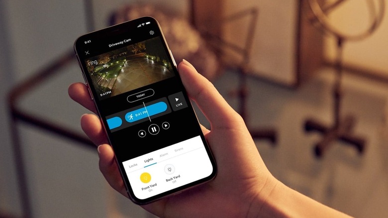 Person using phone to monitor Ring Bridge lighting setup