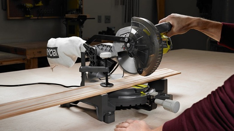 Person using Ryobi miter saw