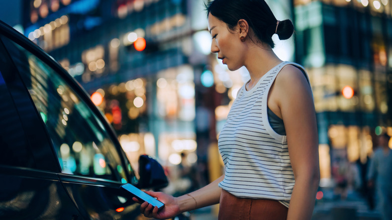 A person unlocking a car using a smartphone