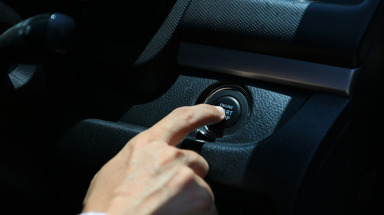 A person starting the car with push button