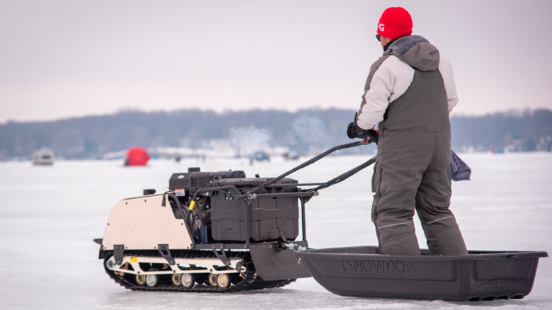 Person riding in Snowdog mechanical sled