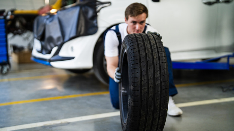 Mechanic inspecting tire
