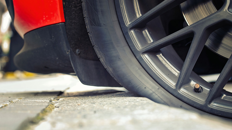 Vehicle tire pressing against curb