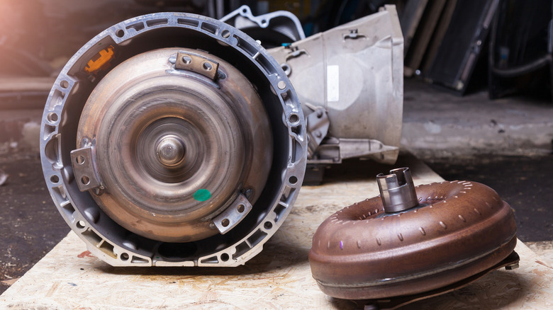 Two torque converters, one installed in automatic transmission and the other placed on floor beside it