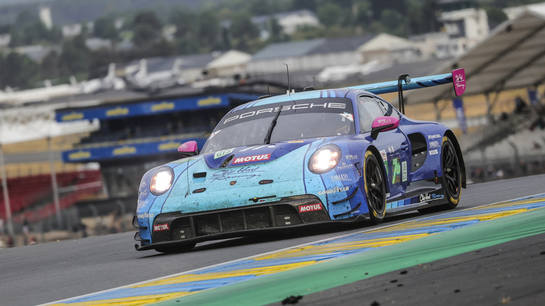 A Porsche GT3 RSR on a race track, front 3/4 view