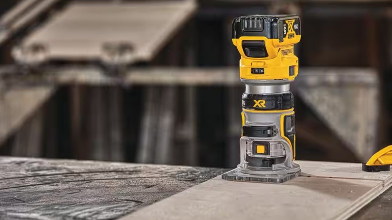 A DeWalt compact router on top of a board