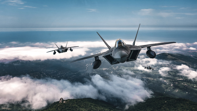 Two fighter jets flying together