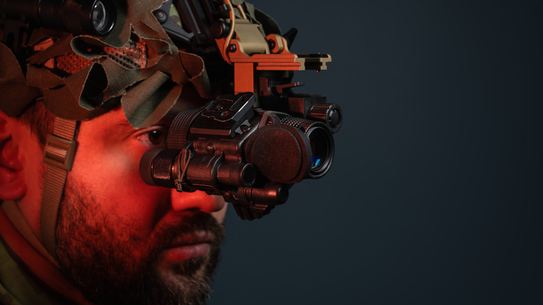 A man in a tactical helmet with a night vision monocular.