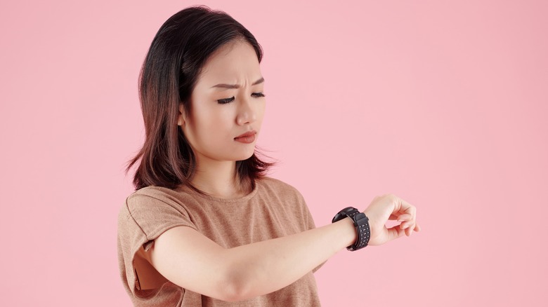 person frowning at smart watch