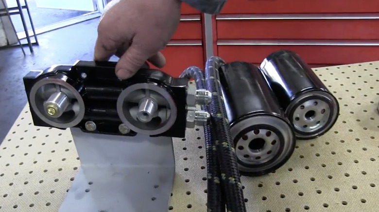 An Amsoil bypass oil filter sits on a table before installation