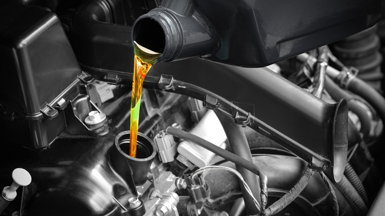 Pouring engine oil into a diesel truck