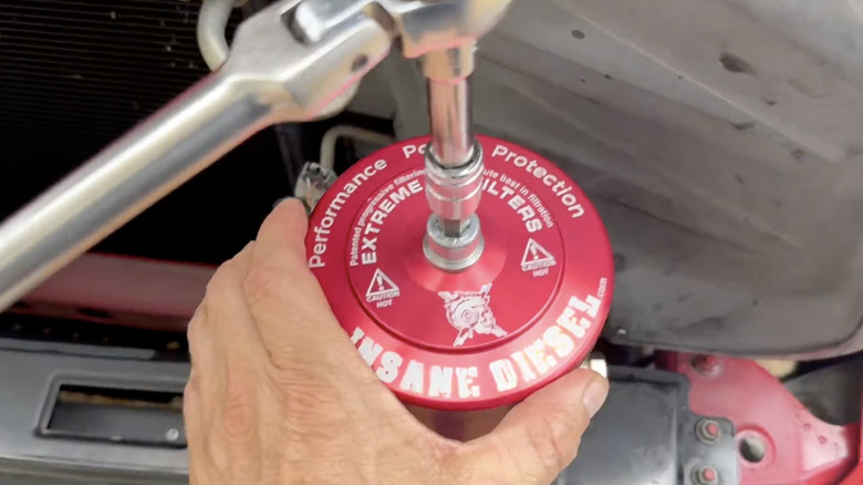 An Extreme bypass oil filter being installed on a Toyota Tundra