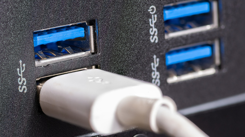 Four blue USB SuperSpeed ports with one cable plugged in
