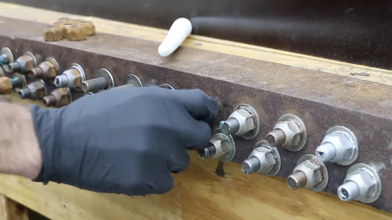 A bunch of nuts and bolts with anti seize applied on them