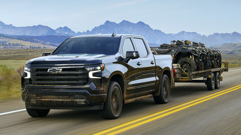 2025 Chevrolet Silverado 1500 pickup truck towing trailer of ATVs