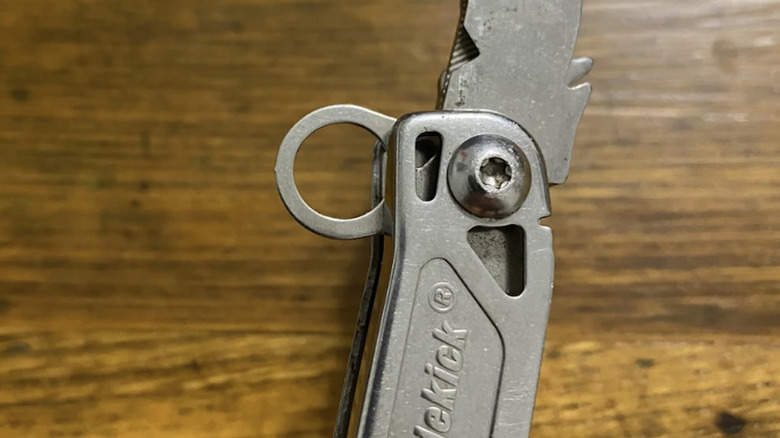 A silver little circle extending from a Leatherman pocket knife