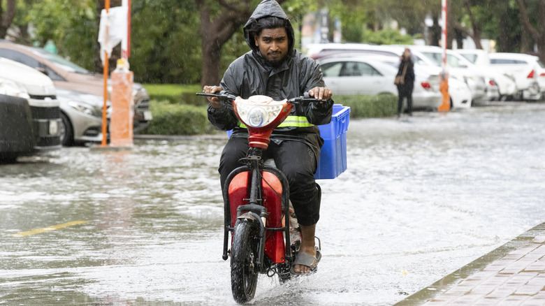 person on a bike on a flooded street