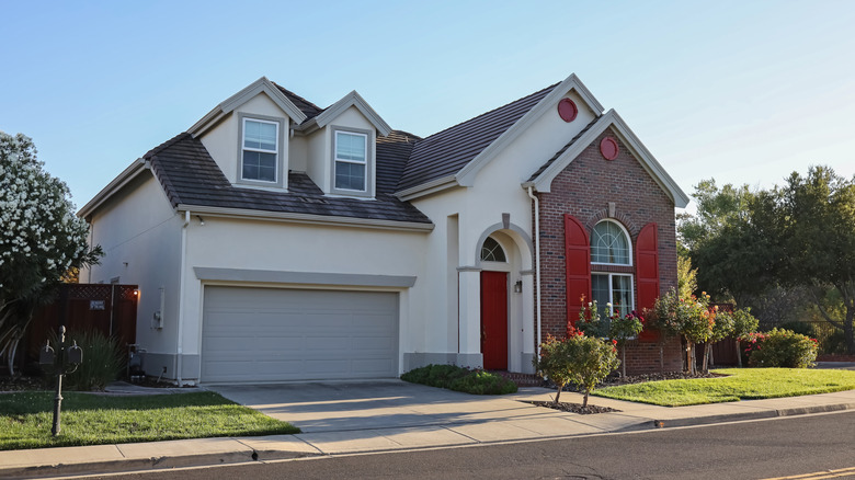 View of a suburban single-story house with garage attached.