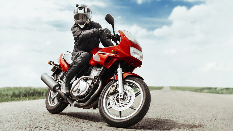 Man riding red motorcycle
