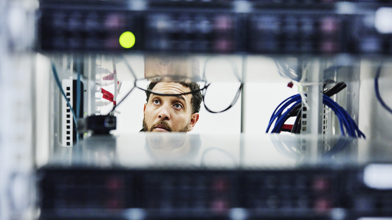 Man viewed through server racks