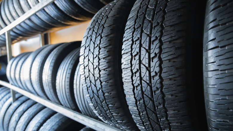 Rows of tires on rack in store