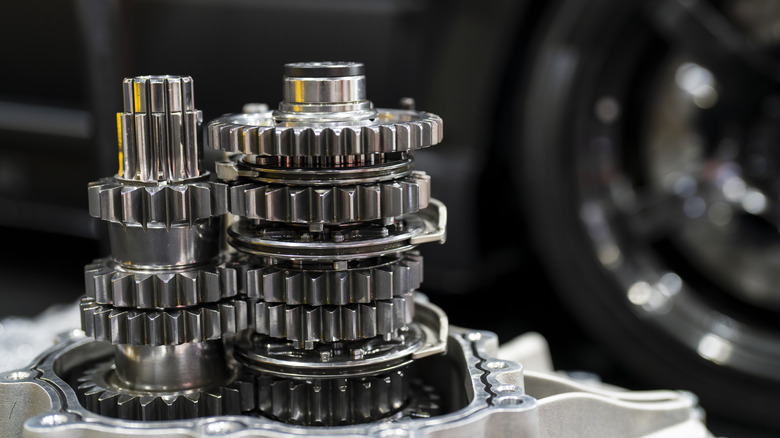 Close-up of exposed gears in manual transmission with synchronizer collars between gears present