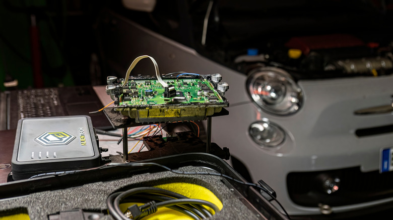 A car's ECU is being tuned using the pin out method