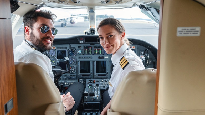 A male and female pilot ready for takeoff