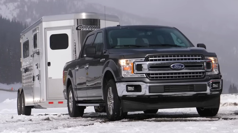 Front-side profile of a Ford F-150 with a Cimarron trailer hitched