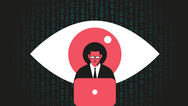 A man works on code before the watchful eye of big brother