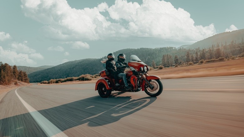 Two riders on an open road riding the Harley-Davidson Tri Glide Ultra.