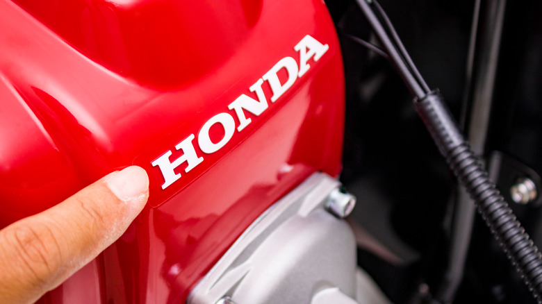 Pointing at Honda logo