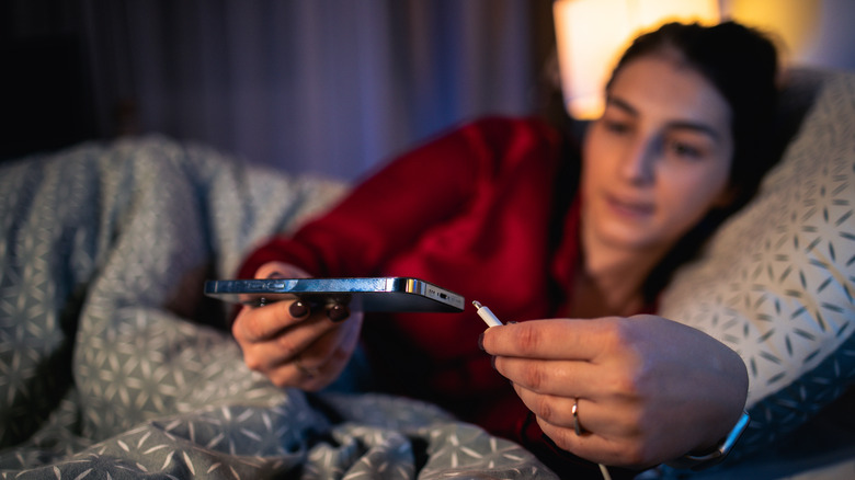 woman charging an iPhone