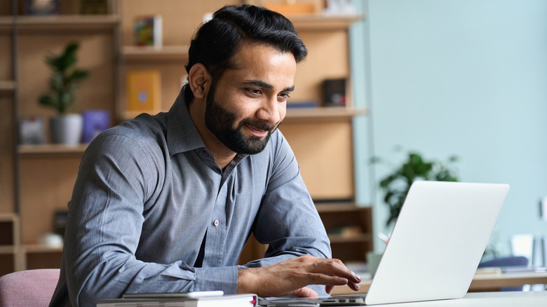 person typing on laptop